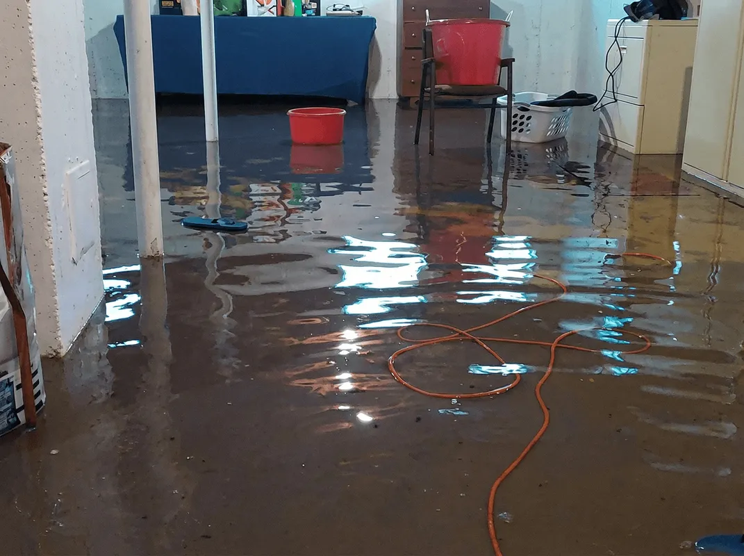 Basement with boiler, cabinets and washing machine completely flooded in Ann Arbor, MI